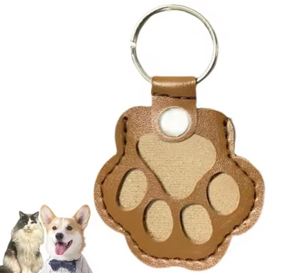 Brown paw-shaped keychain with a white background
